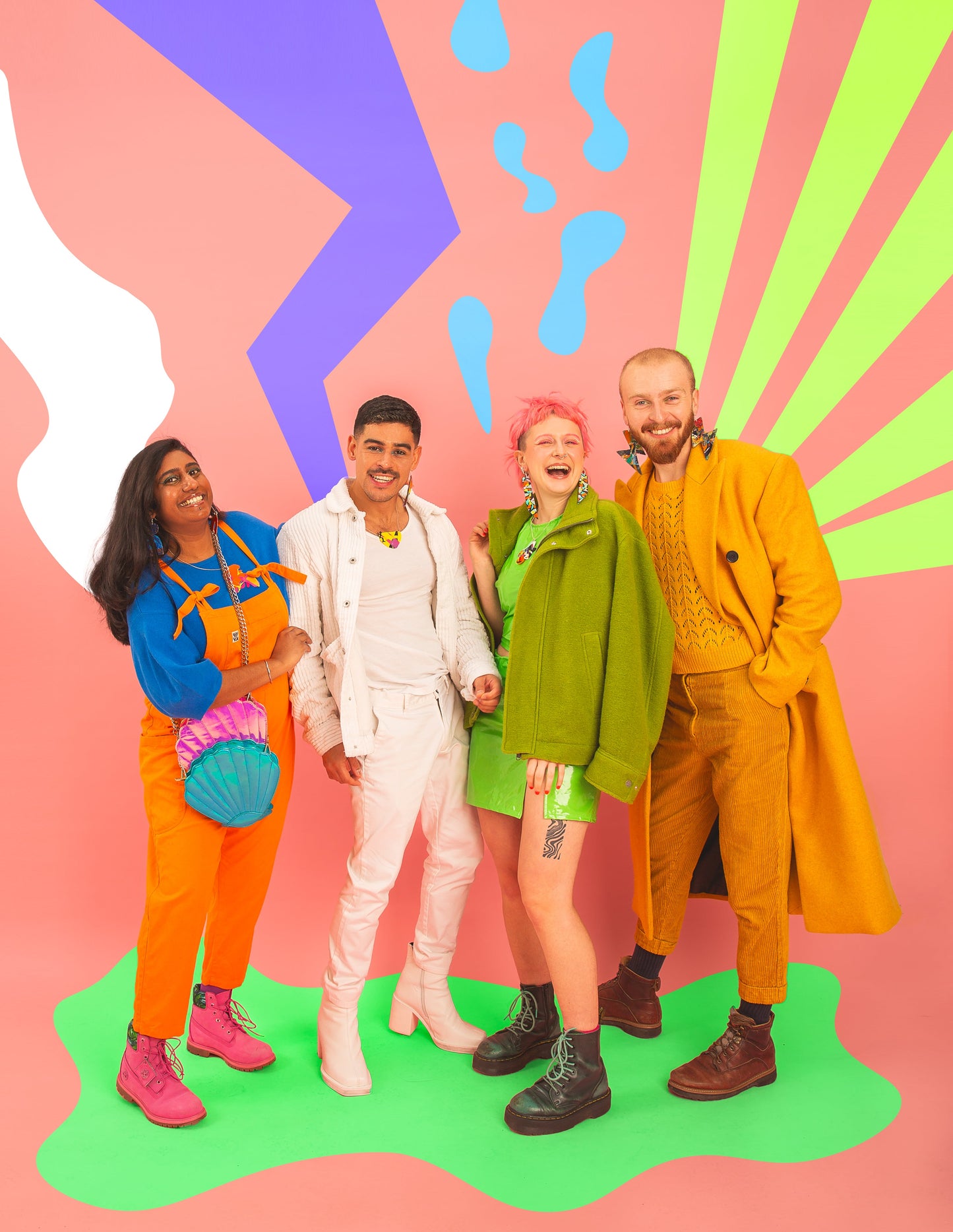 Four happy people, two men and two women smiling wearing brightly coloured outfits in PLASTIQUE By Sian Jewellery 