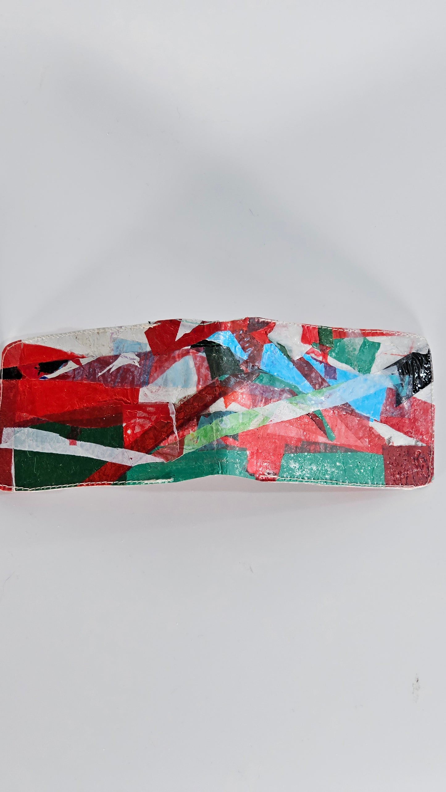 Card wallet: Green, black, blue, red and white stitched from upcycled plastic - PLASTIQUE By Siân