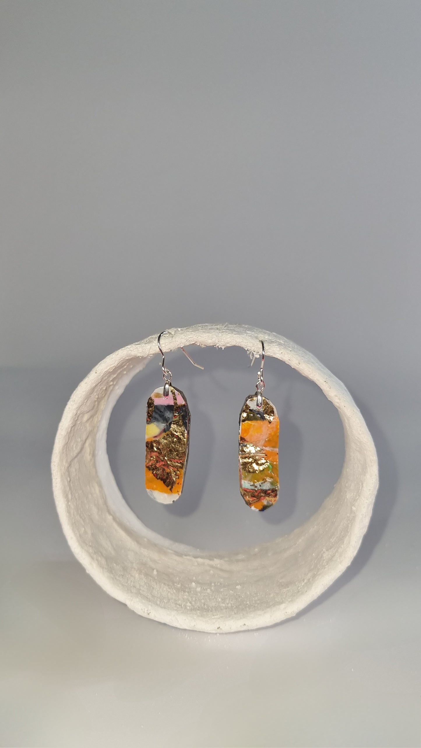 Small oval thin earrings in orange, black, and white with gold foiling overlay - PLASTIQUE By Siân