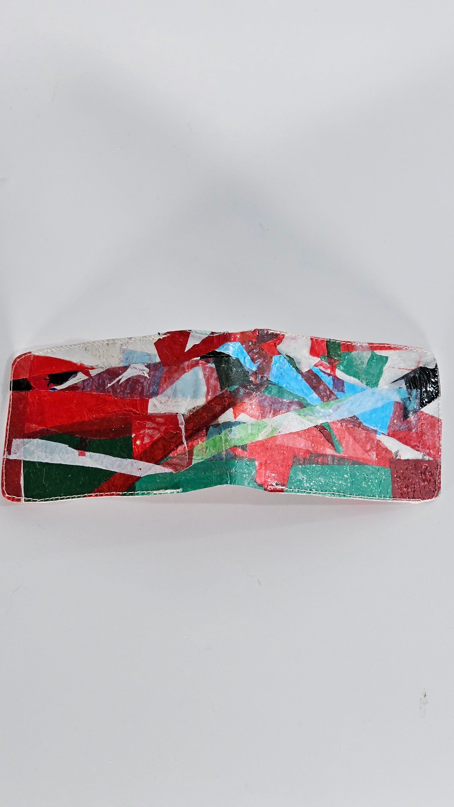 Card wallet: Green, black, blue, red and white stitched from upcycled plastic - PLASTIQUE By Siân