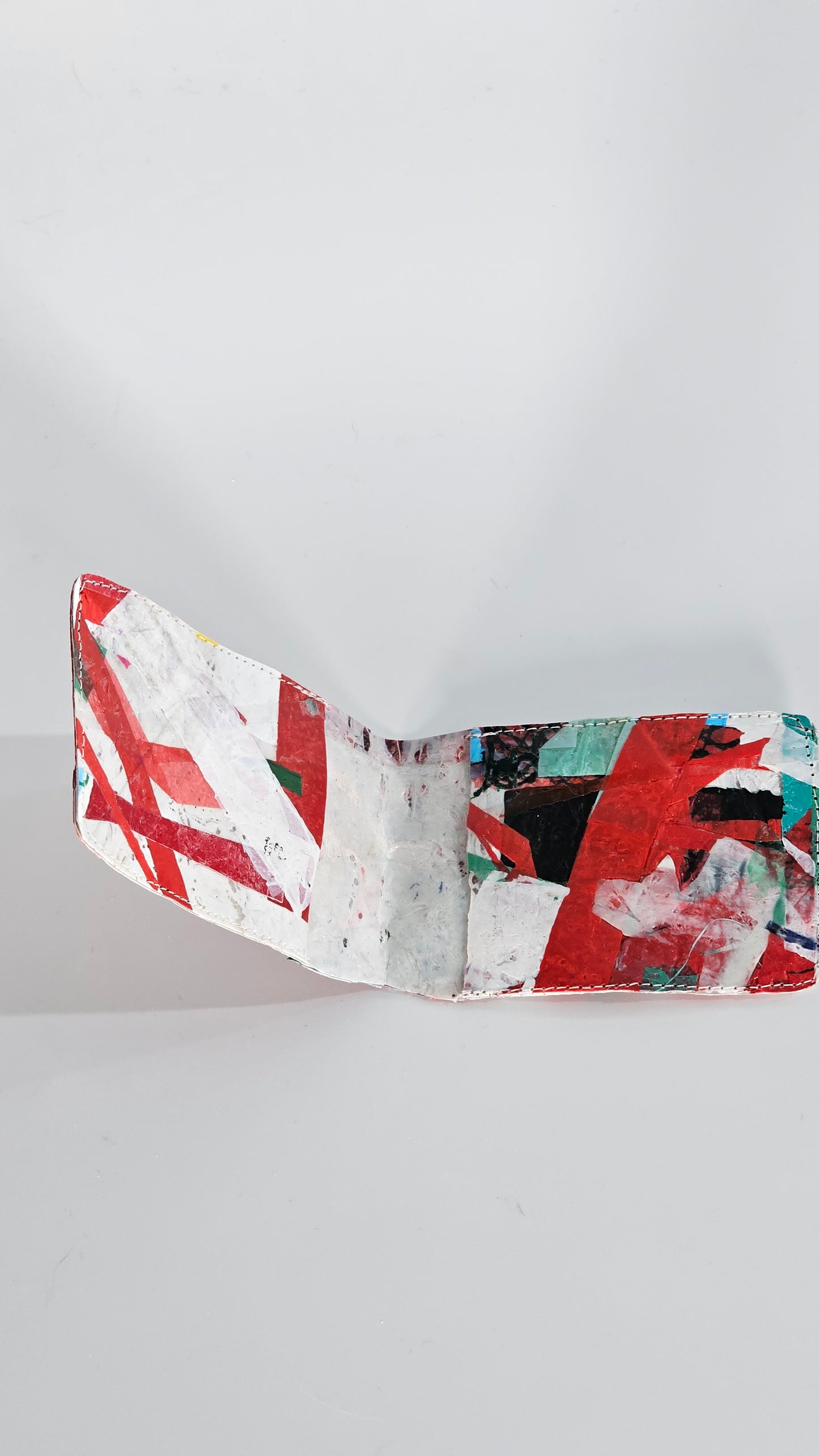 Card wallet: Green, black, blue, red and white stitched from upcycled plastic - PLASTIQUE By Siân