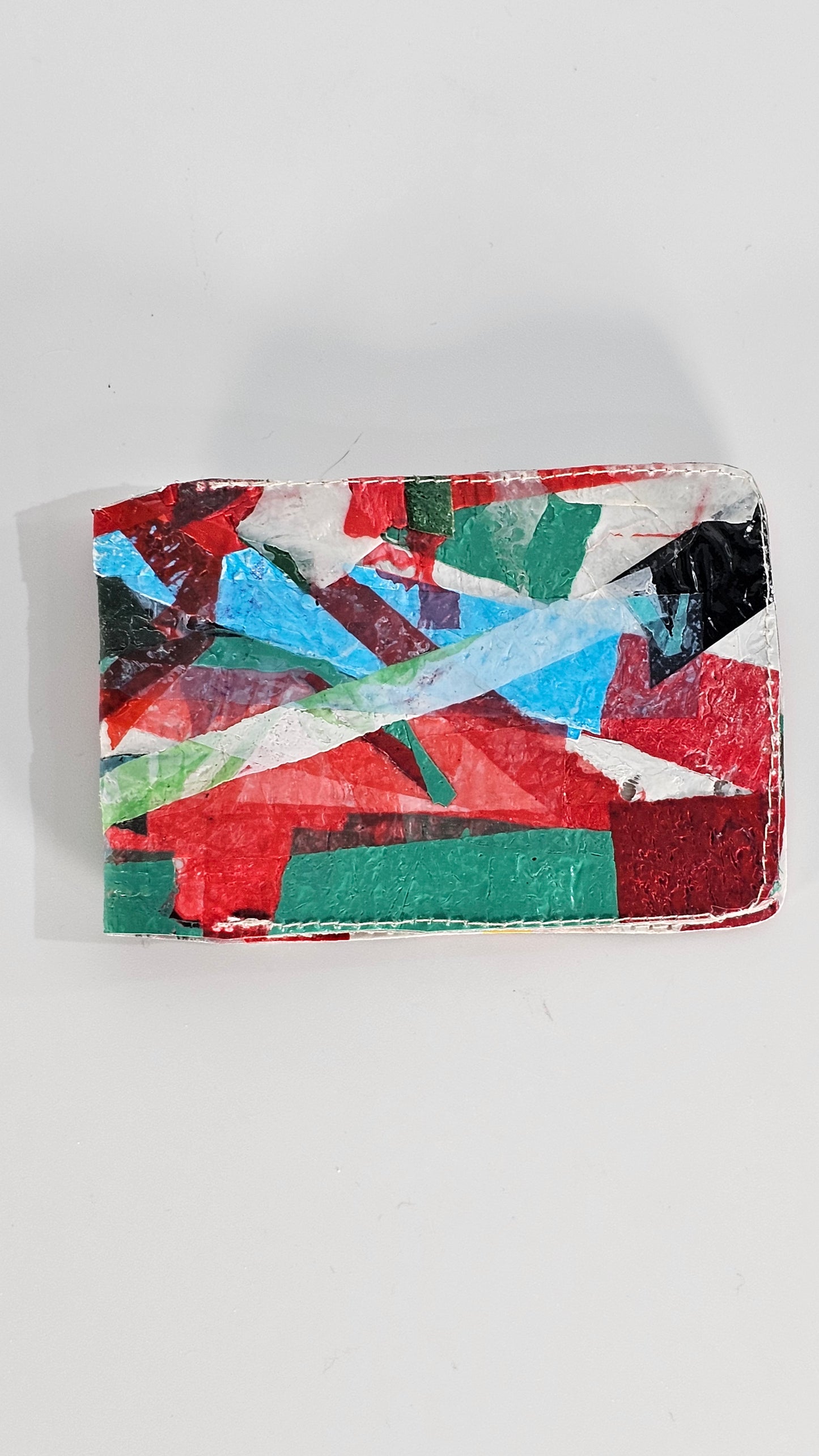 Card wallet: Green, black, blue, red and white stitched from upcycled plastic - PLASTIQUE By Siân